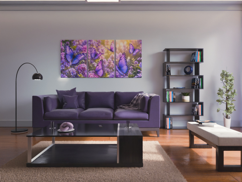 Grey couch with cushions beneath a purple butterfly canvas, coffee table in front